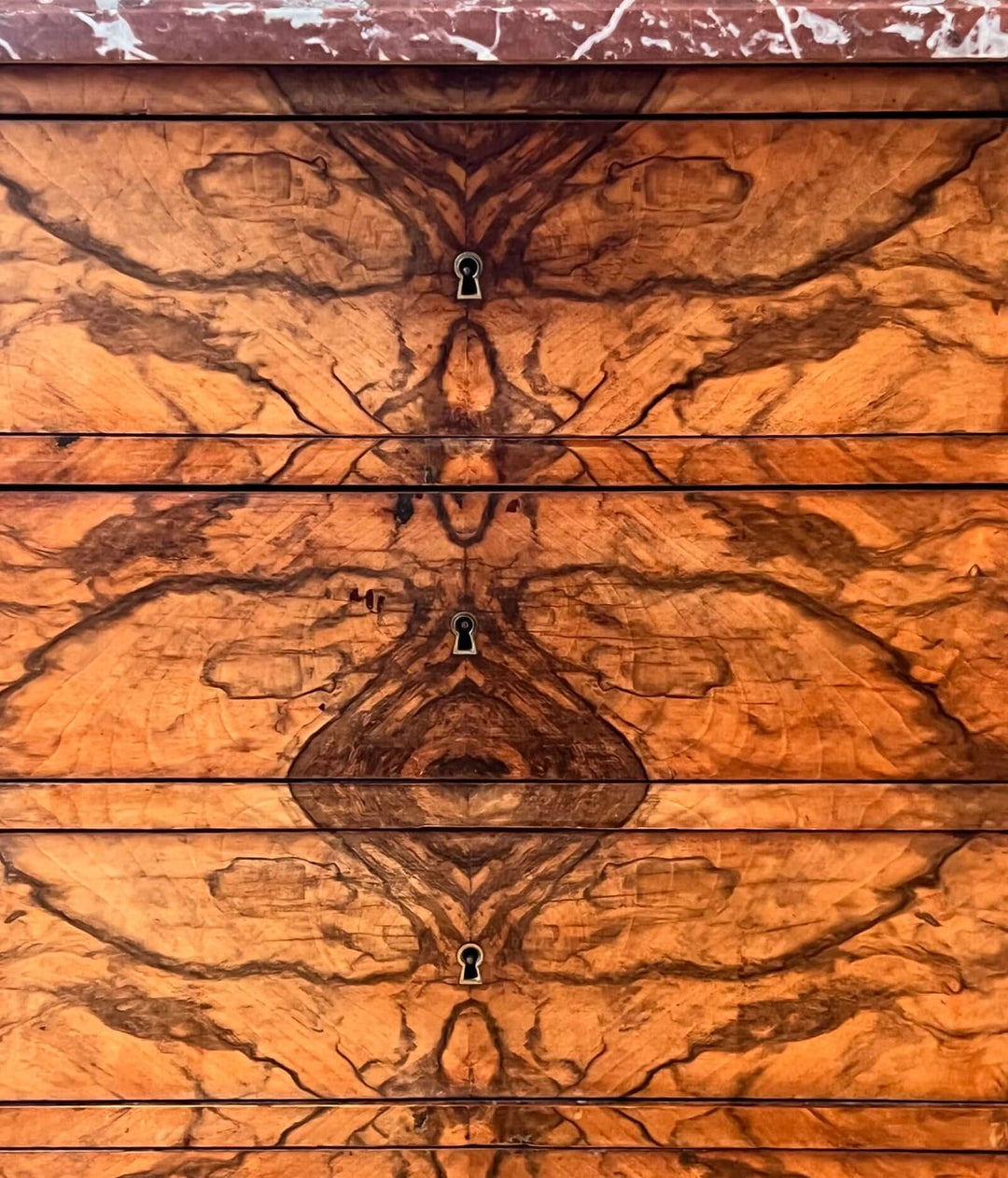 19th-century French Louis-Philippe Marble-top Commode with intricate hand-veneered walnut drawer fronts.