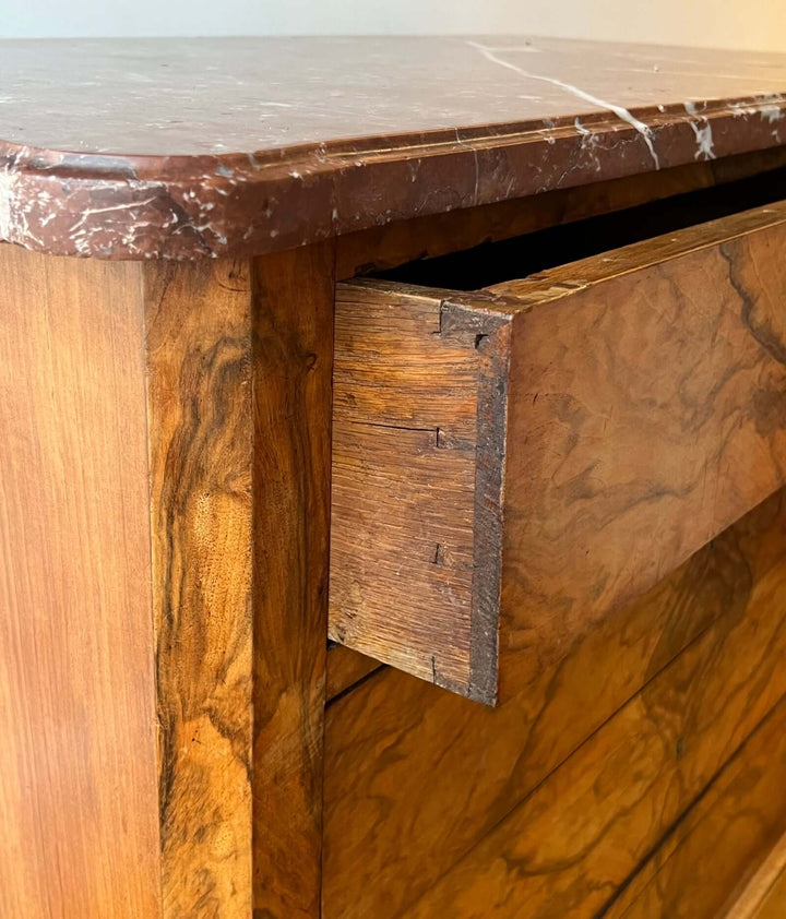 Close-up of 19th-century French Louis-Philippe Marble-top Commode showing Rouge-Royal marble and dovetail joinery.