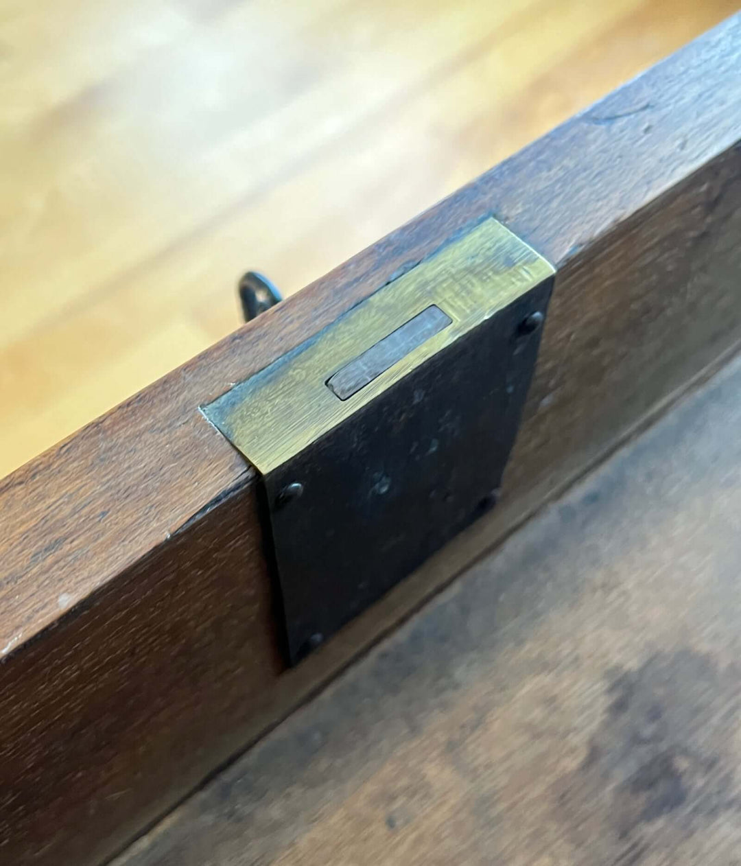 Detail of brass escutcheon on the 19th-century French Louis-Philippe Marble-top Commode showcasing craftsmanship.