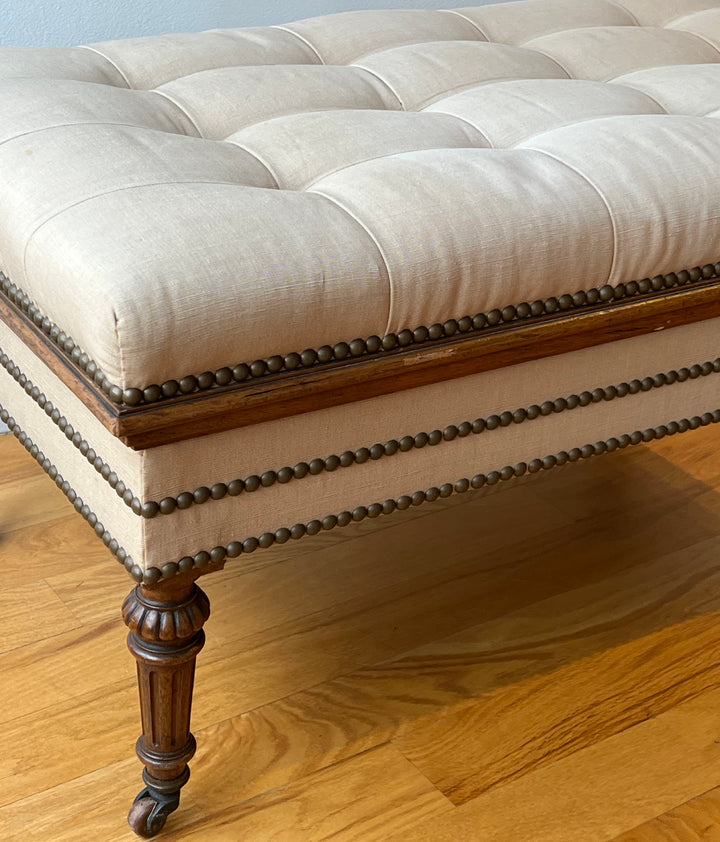 Antique English Tufted Storage Bench on Fluted Legs with Casters detail showcasing tufted upholstery and nailhead trim.