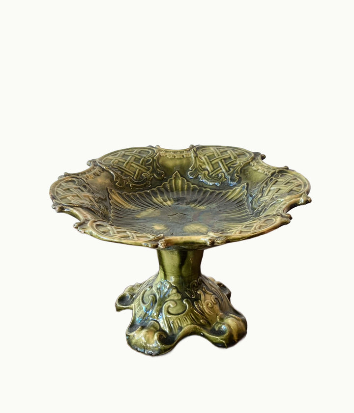 Antique European Majolica Compote with Ornate Relief and Green Glaze displayed on a neutral background.
