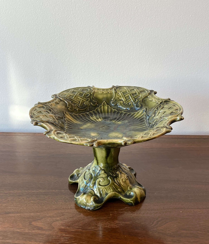 Antique European Majolica Compote with Ornate Relief and Green Glaze on a wooden surface