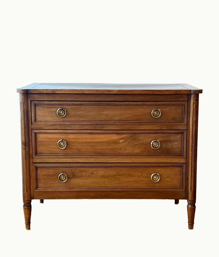 Early 19th Century French Louis XVI Style Walnut Three-Drawer Commode with brass-ring pulls and tapered legs.