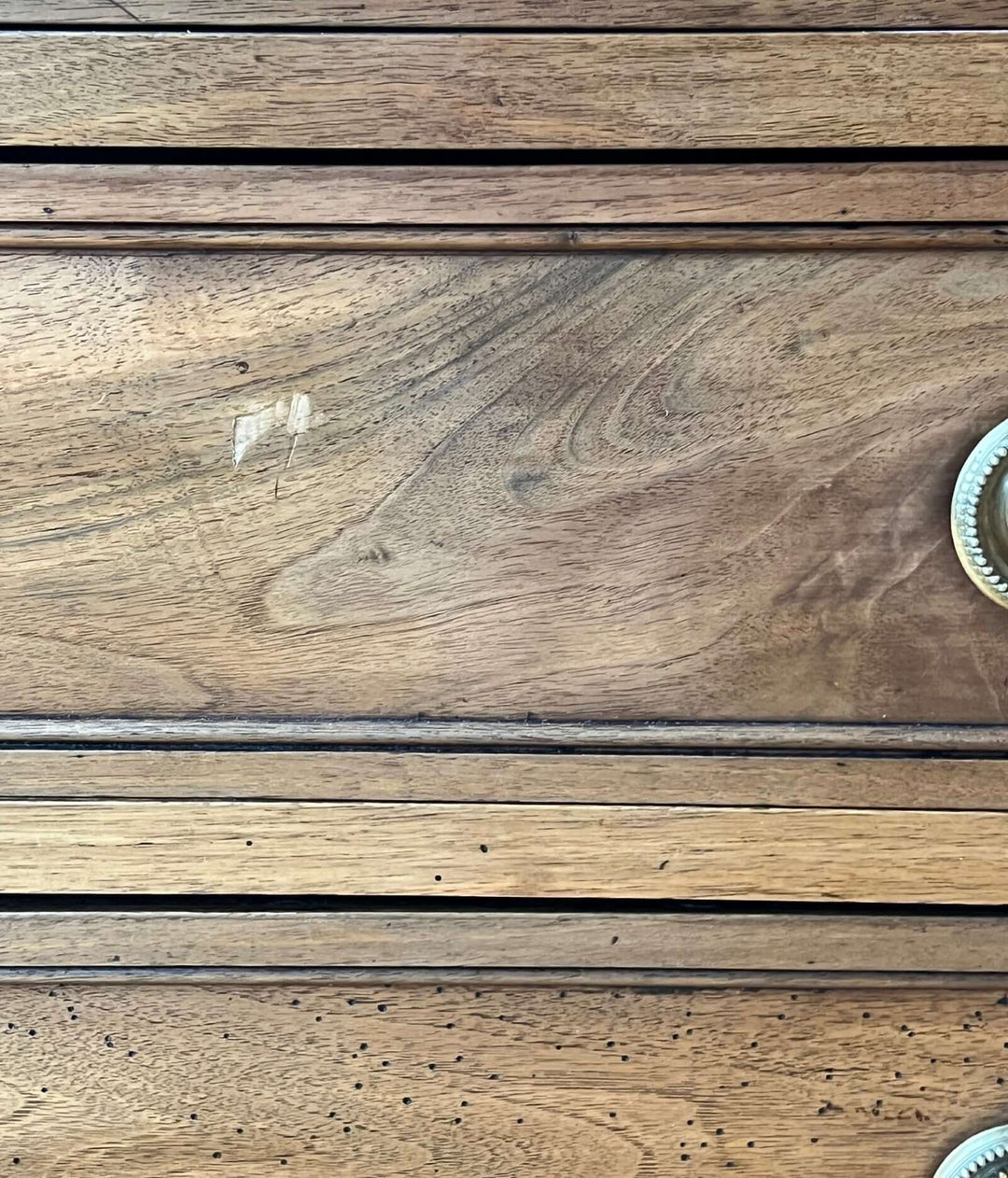 Close-up of the surface detailing of an Early 19th Century French Louis XVI Style Walnut Three-Drawer Commode.