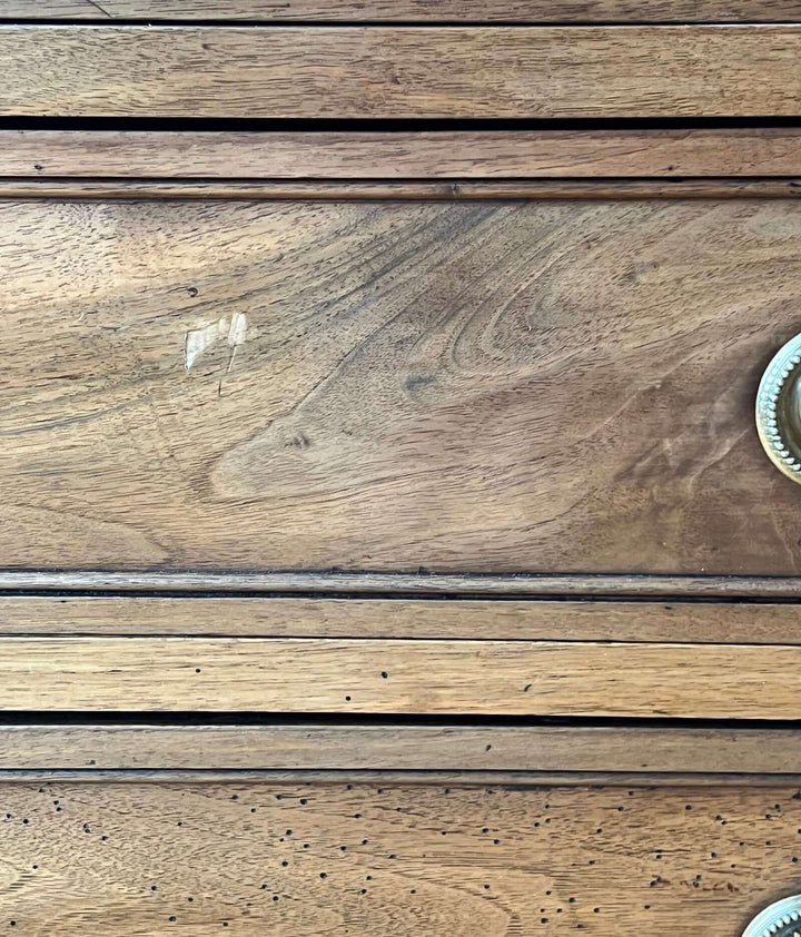 Close-up of the surface detailing of an Early 19th Century French Louis XVI Style Walnut Three-Drawer Commode.