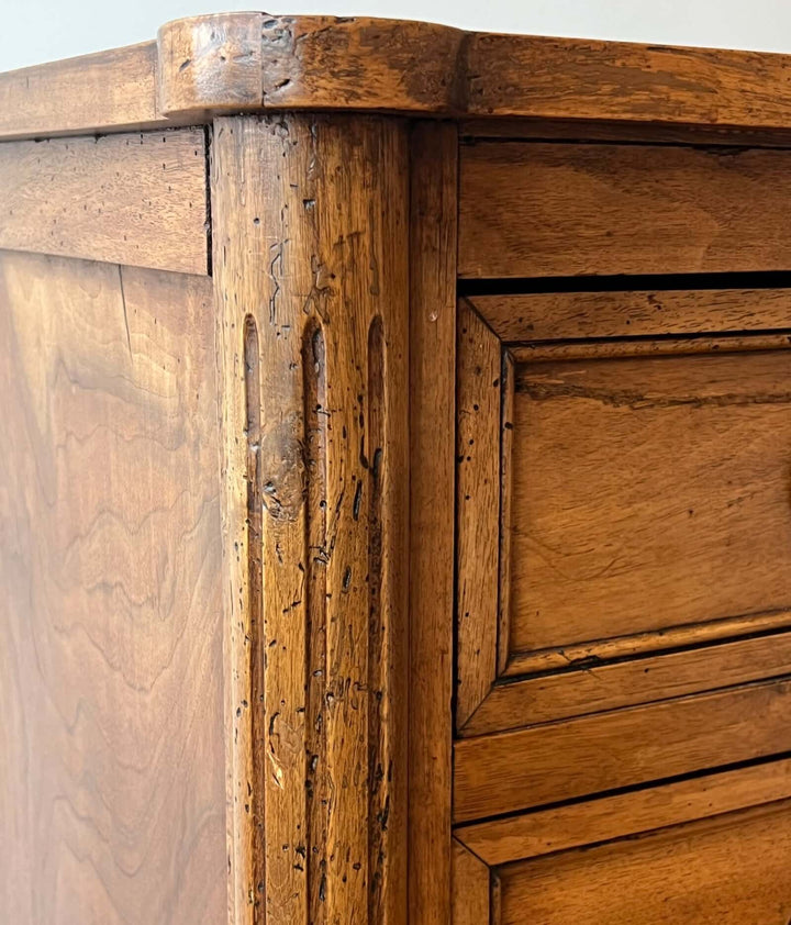 Close-up view of the Early 19th Century French Louis XVI Style Walnut Three-Drawer Commode showing details and craftsmanship.