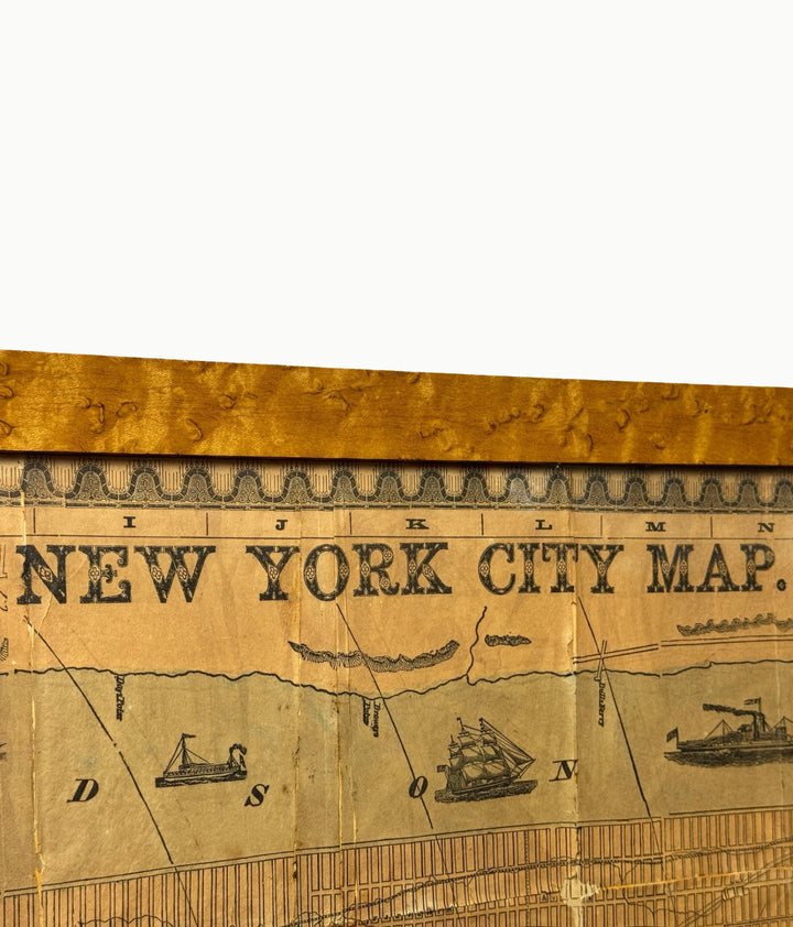 detail of qntique framed map of new york city in burlwood frame