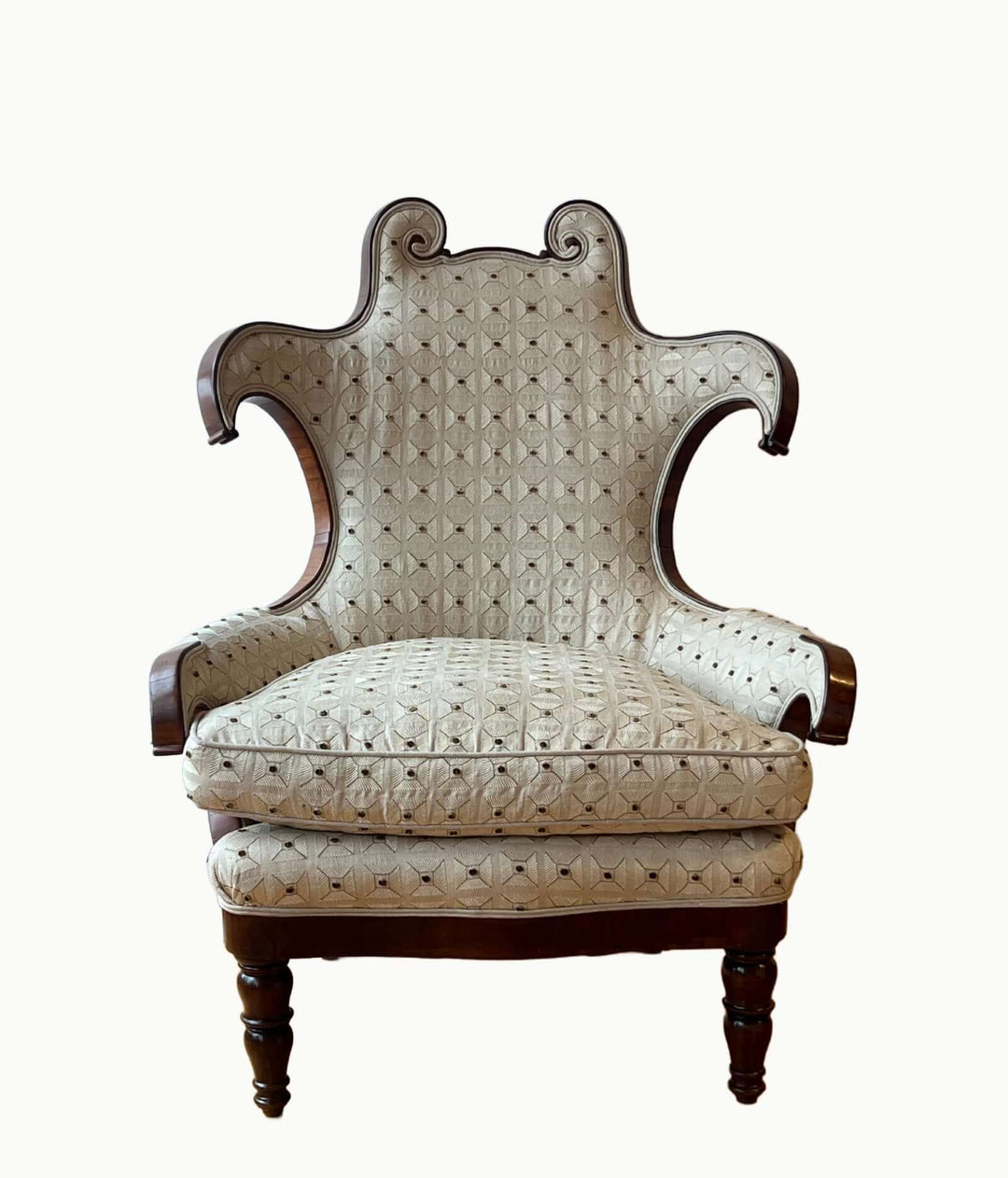 Antique Scroll-Crest Upholstered Armchair in Mahagony Frame with whimsical design and plush cushions.