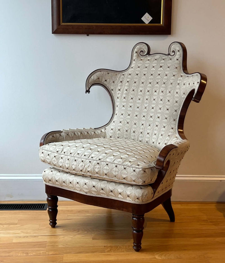 Antique Scroll-Crest Upholstered Armchair in Mahagony Frame showcased with intricate upholstery and elegant design.