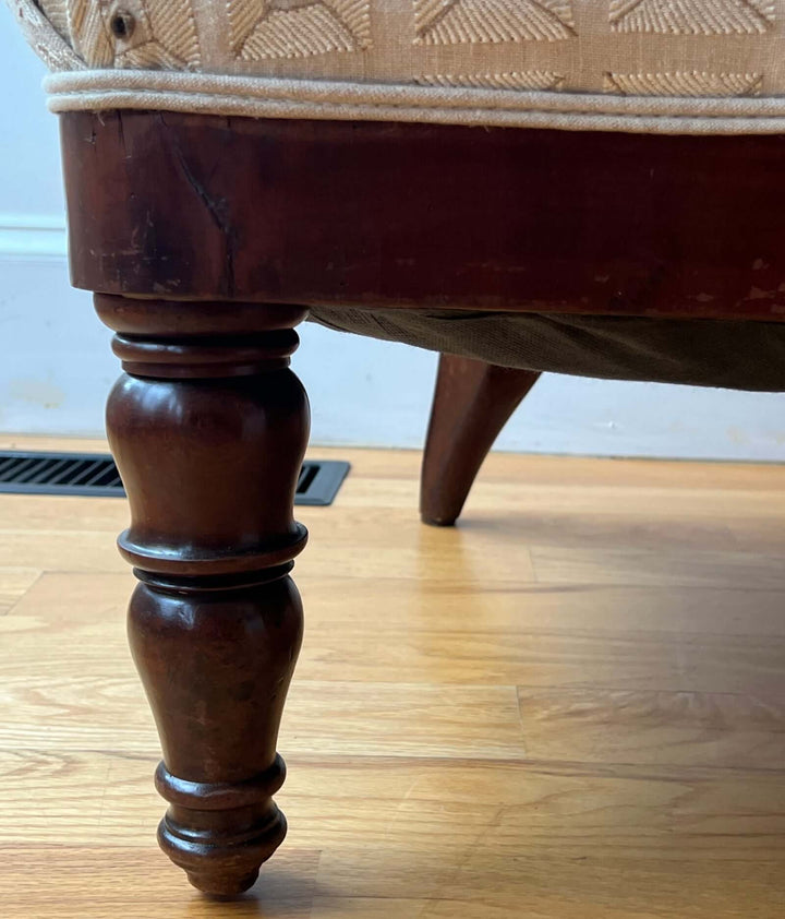 Antique Scroll-Crest Upholstered Armchair in Mahagony Frame showcasing detailed leg design and rich mahogany finish.