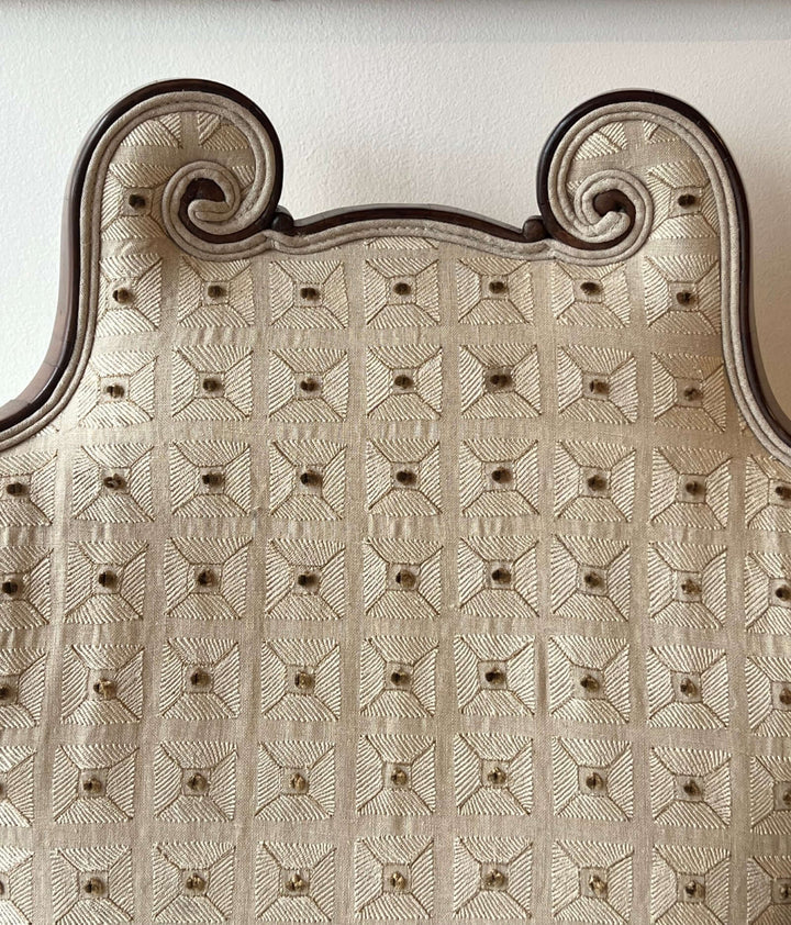 Antique Scroll-Crest Upholstered Armchair in Mahagony Frame showcasing a detailed scroll-crest back design.