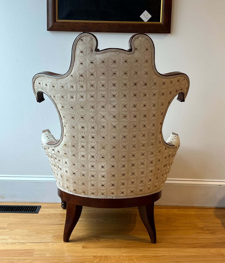 Antique Scroll-Crest Upholstered Armchair in Mahagony Frame showcasing whimsical back design and rich upholstery.