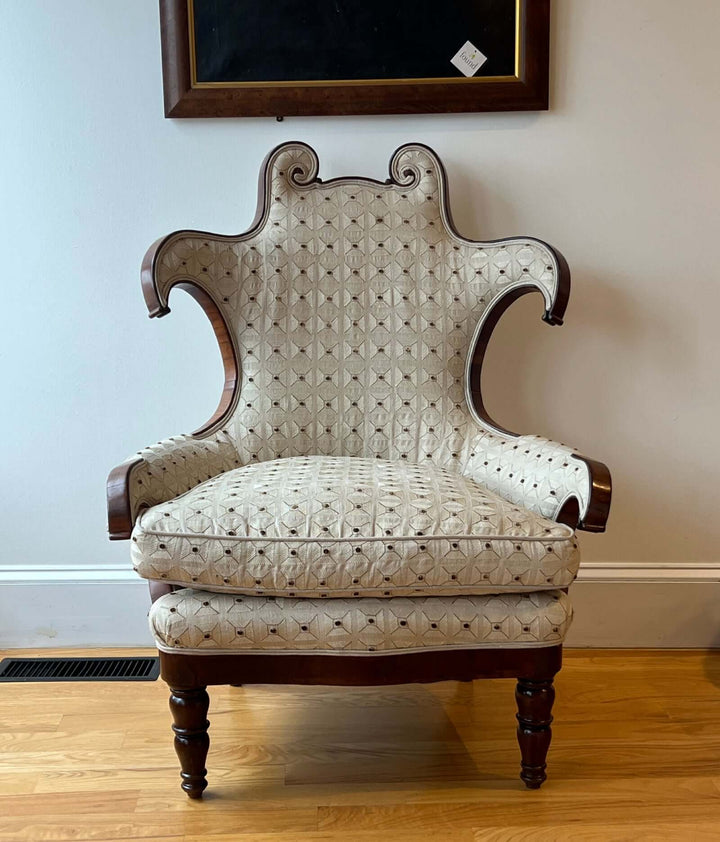 Antique Scroll-Crest Upholstered Armchair in Mahagony Frame with scroll-crest back and elegant upholstery.