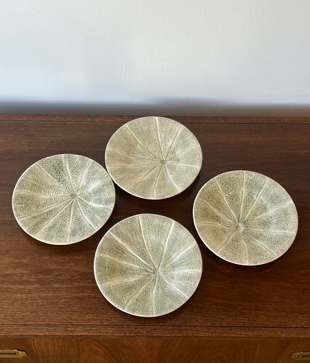 Set of Bordallo Pinheiro Melon Dessert Plates from Portugal arranged on a wooden surface.