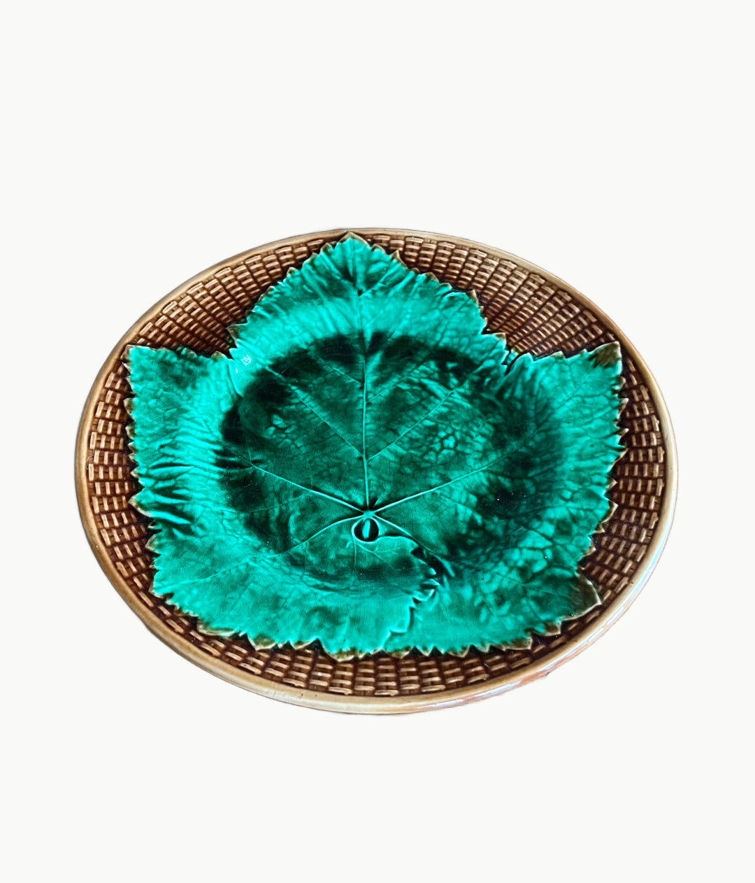 Antique French majolica plate with vibrant green grape leaf design and brown basketweave border, circa 1900