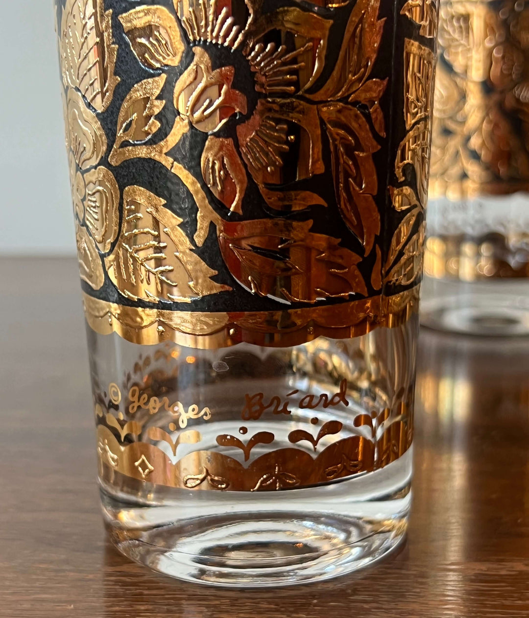 Set of Georges Briard Gold & Black Floral Highball Glasses with ornate gold floral design and clear base.