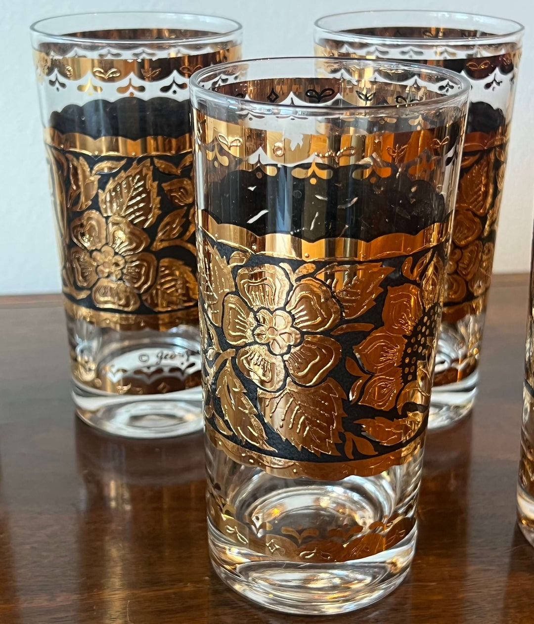 Set of Georges Briard Gold & Black Floral Highball Glasses with bold black and gold floral motif.