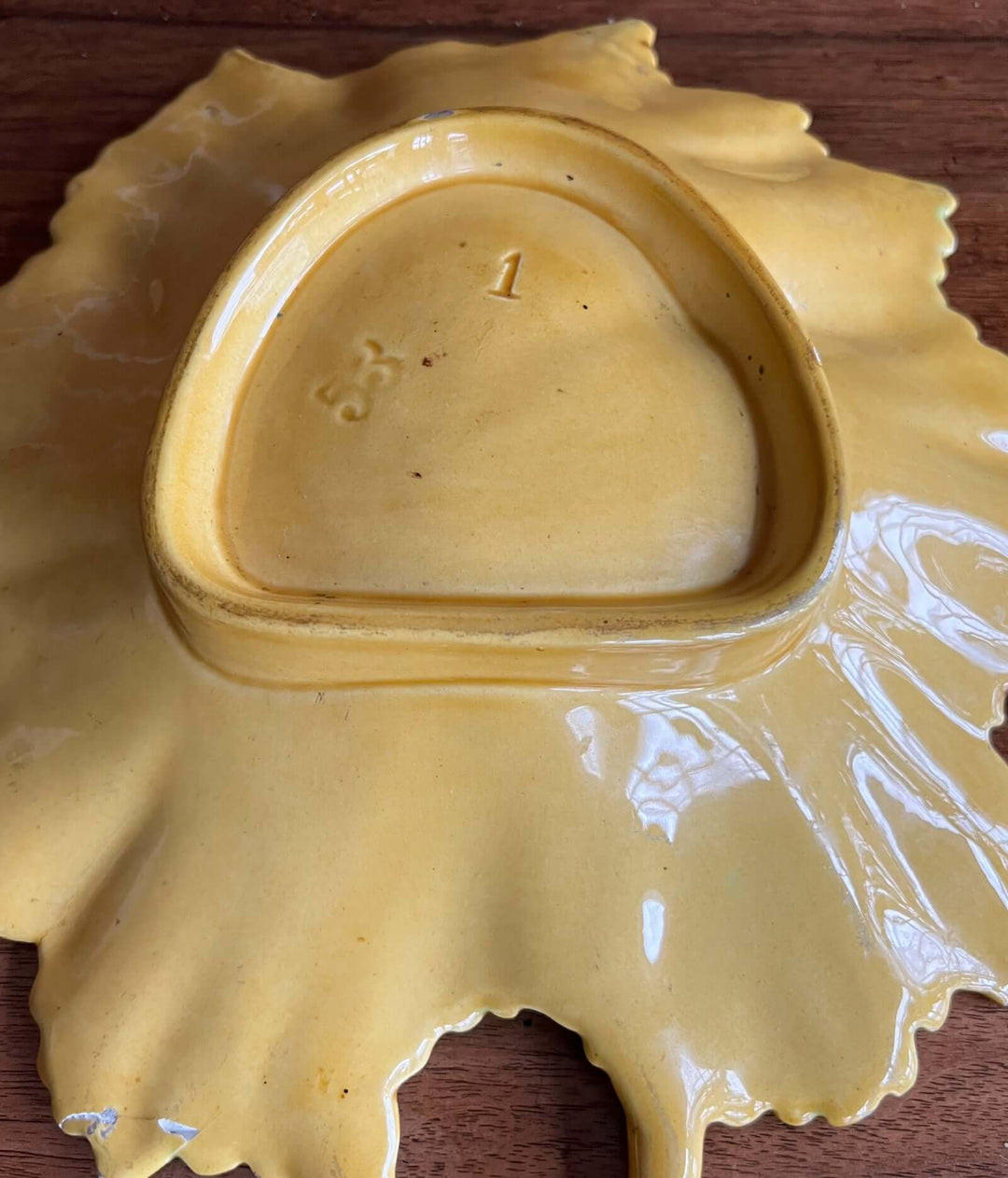 Bottom view of Vintage Portuguese Majolica Leaf Dish showing markings and natural leaf shape in vibrant yellow glaze.