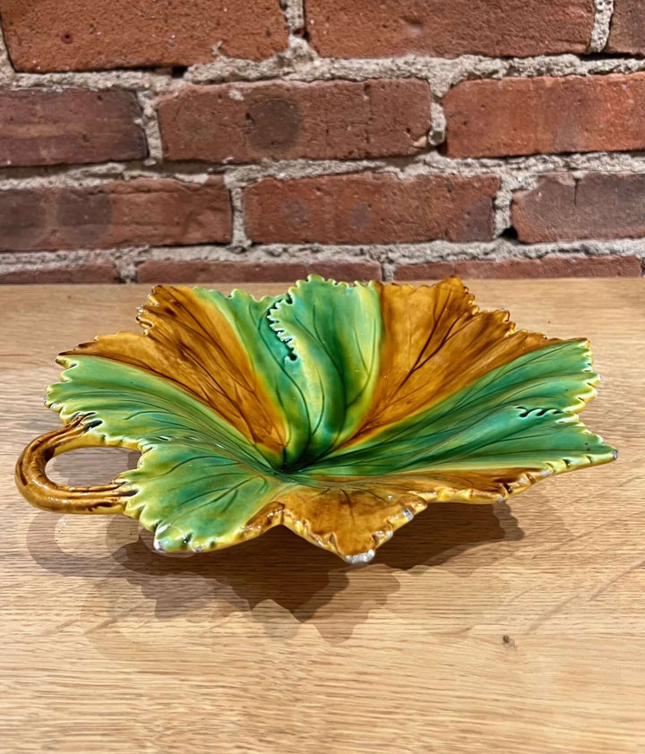 Vintage Portuguese Majolica Leaf Dish in green and amber glaze with vine handle and leaf design.
