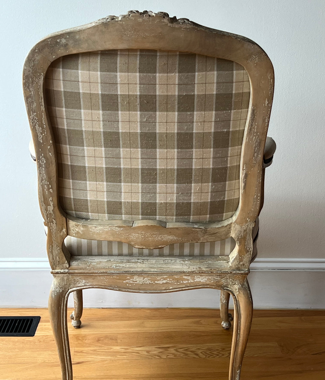 Pair of Vintage Louis XV Style Fateuil armchairs with plaid back and distressed wood frame.