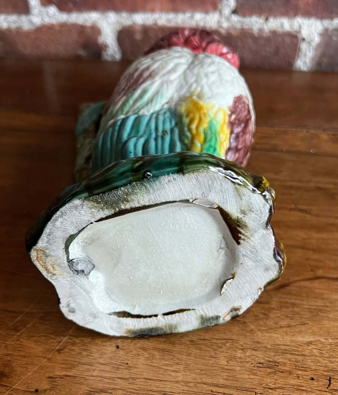 Vintage Majolica Cockatoo Pitcher view from the bottom, showcasing bold colors and unique detailing.