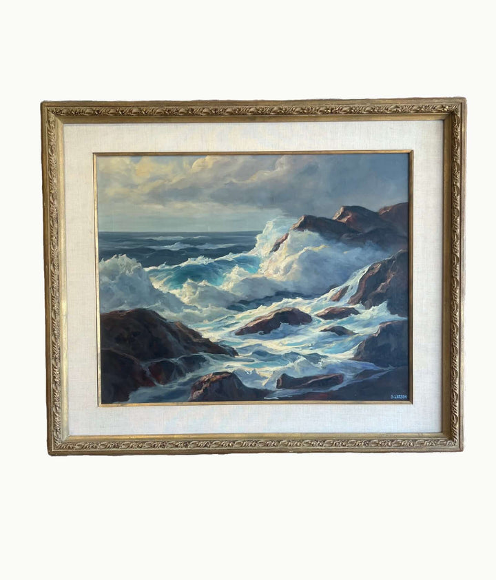 Framed painting of a stormy sea with waves crashing against rocks.