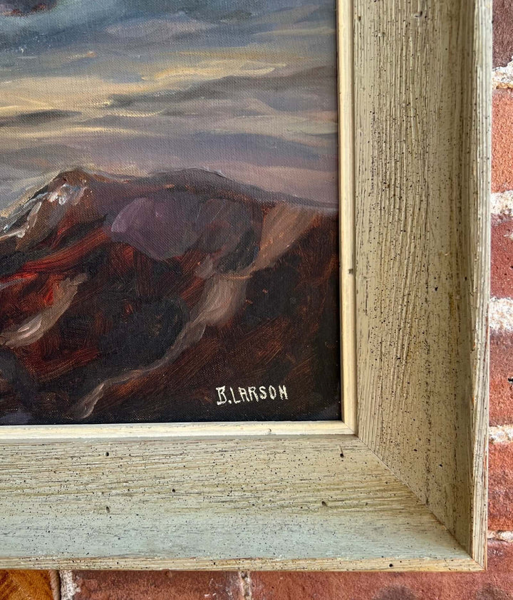 Framed painting of a mountain landscape with 'B. Larson' signature.