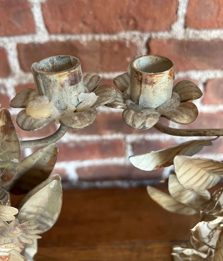 Pair of Vintage Italian Tole Floral Candelabras showcasing distressed paint and floral details for an elegant centerpiece.
