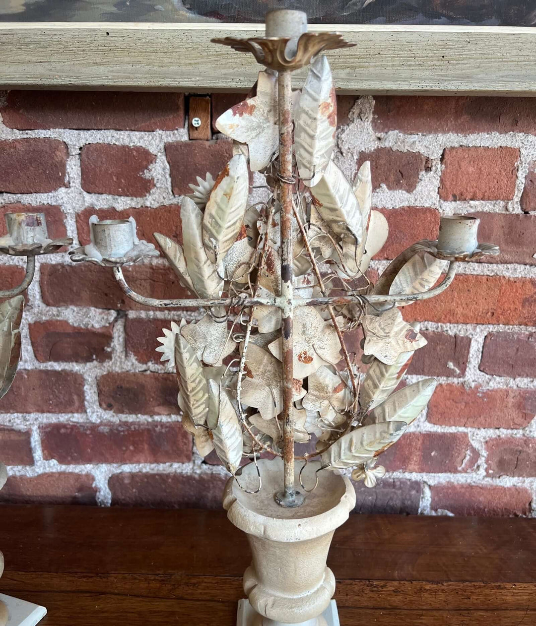 Pair of Vintage Italian Tole Floral Candelabras featuring hand-painted flowers and a classic urn base.