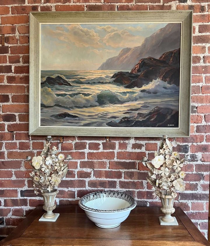 Pair of Vintage Italian Tole Floral Candelabras with a landscape painting and decorative bowl on a wooden table