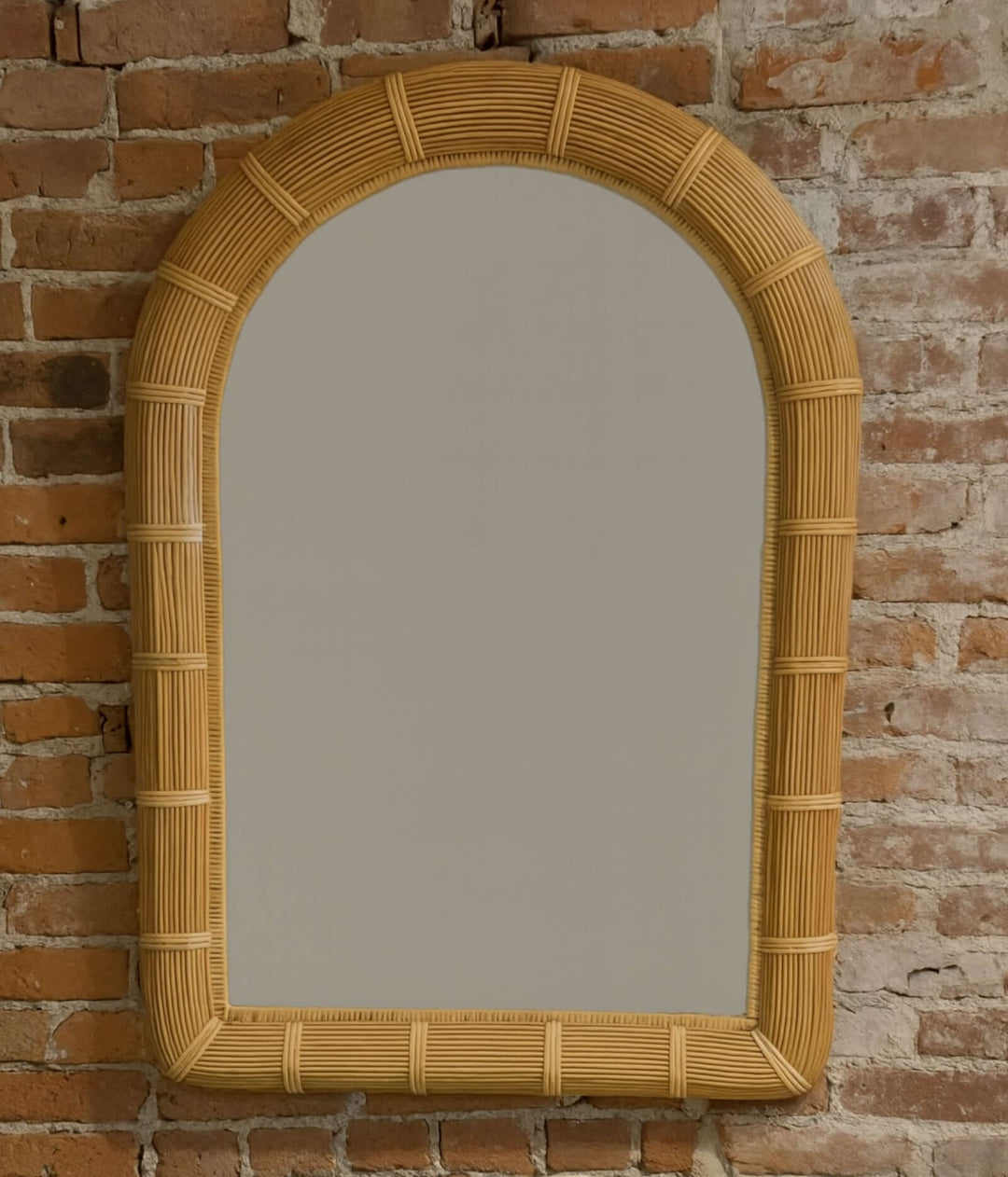 Vintage Rattan Arched Mirror Circa 1970s with natural rattan frame and hand-wrapped bindings.